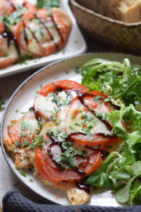 Tomato and mozzarella chicken on a plate.