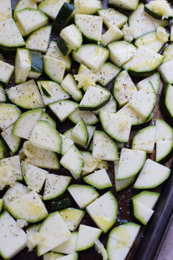 Close up of zucchini on a baking tray.