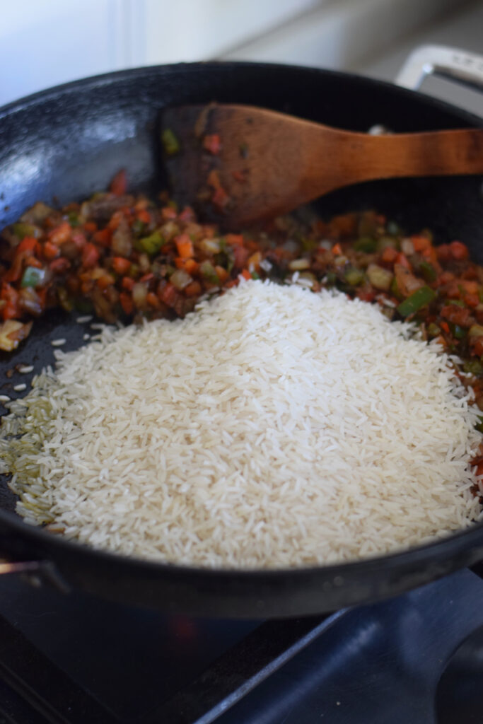 Uncooked rice in a skillet.