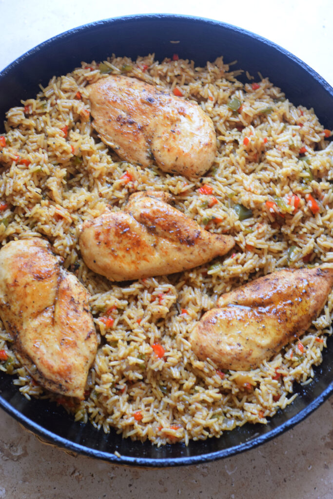 Cooked Cajun chicken and rice in a skillet.