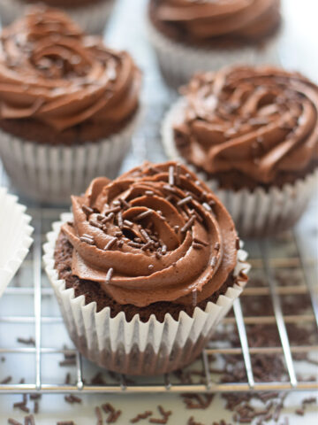 Close up of chocolate frosted cupcakes.