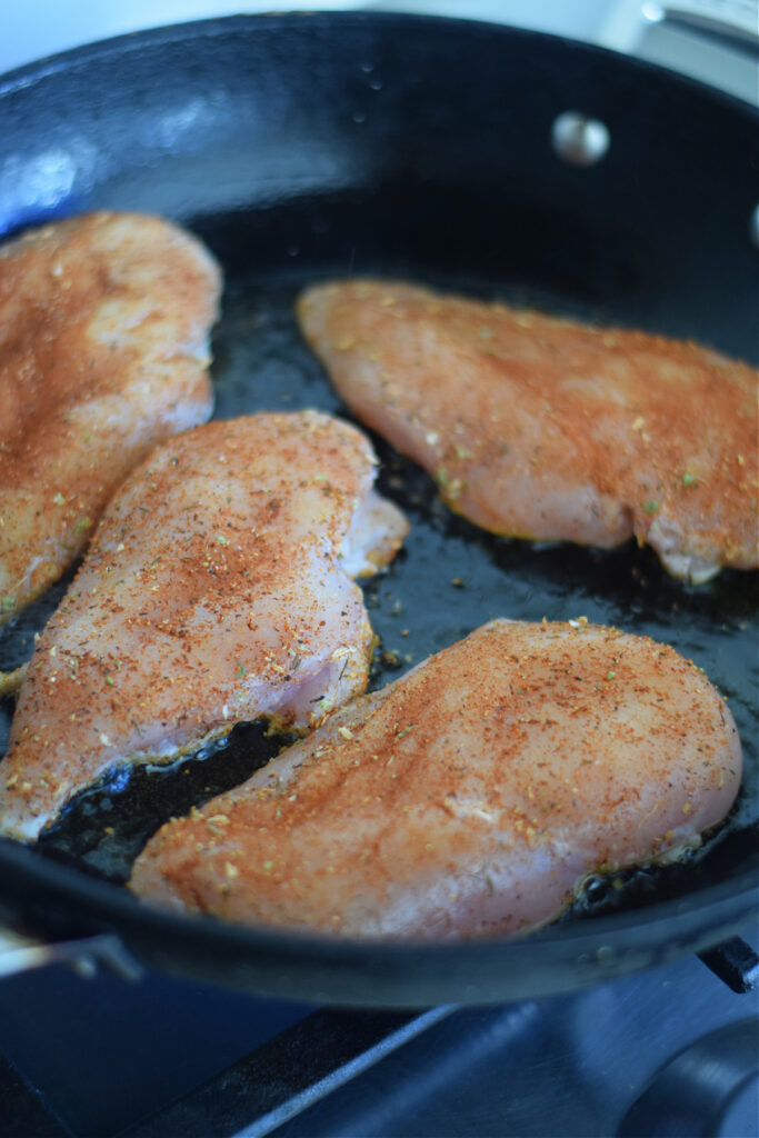 Cooking chicken in a skillet.