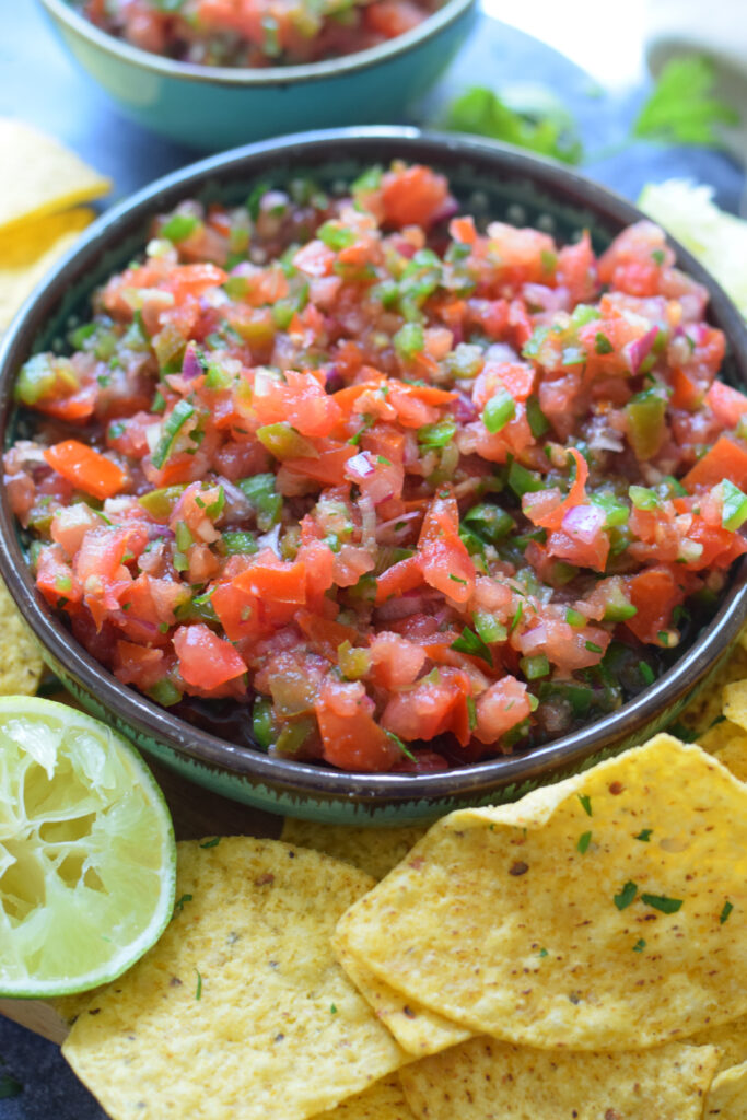 Homemade salsa in a bowl with tortilla chips.