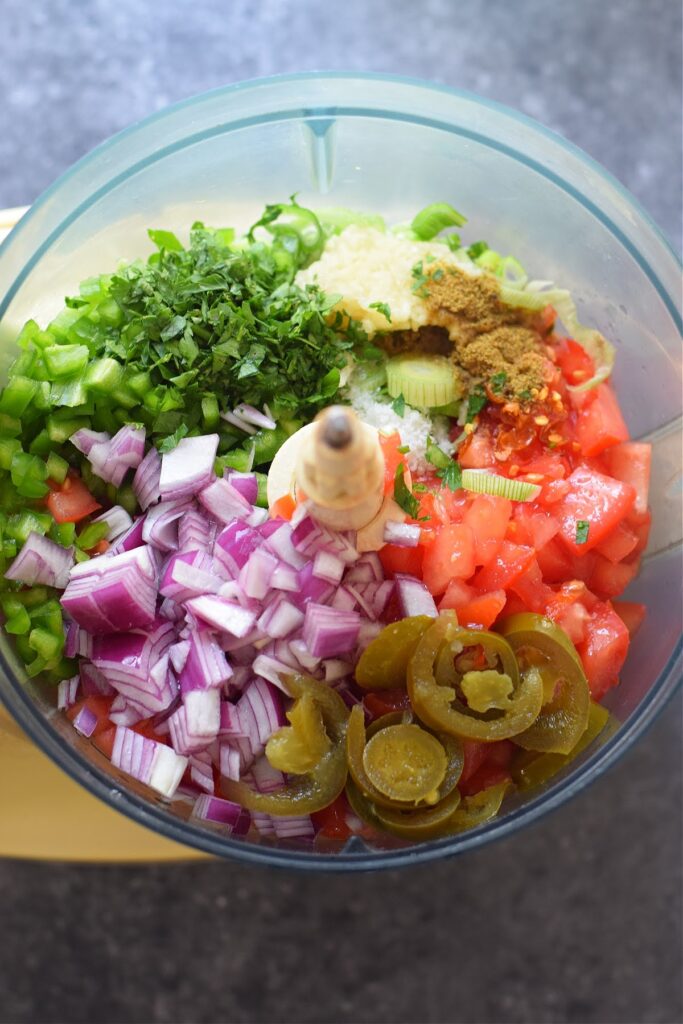 Ingredients in a food processor to make salsa.