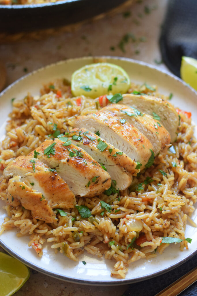 Sliced chicken breast on spiced rice.