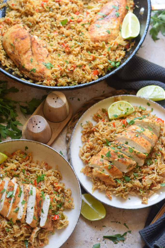 Chicken and rice in a skillet and on plates.