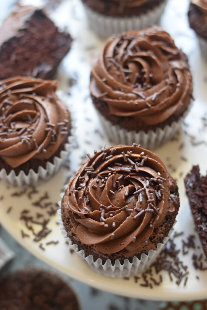 close up of chocolate frosted cupcakes.