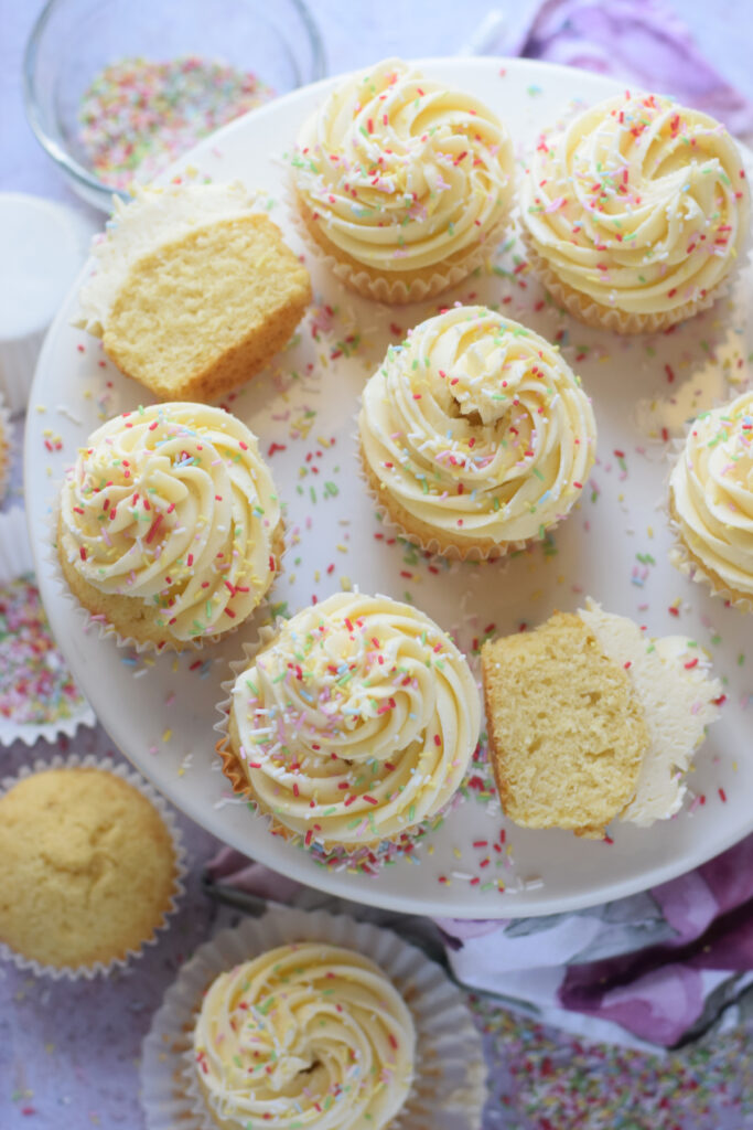 Vanilla cupcakes on a white plate.