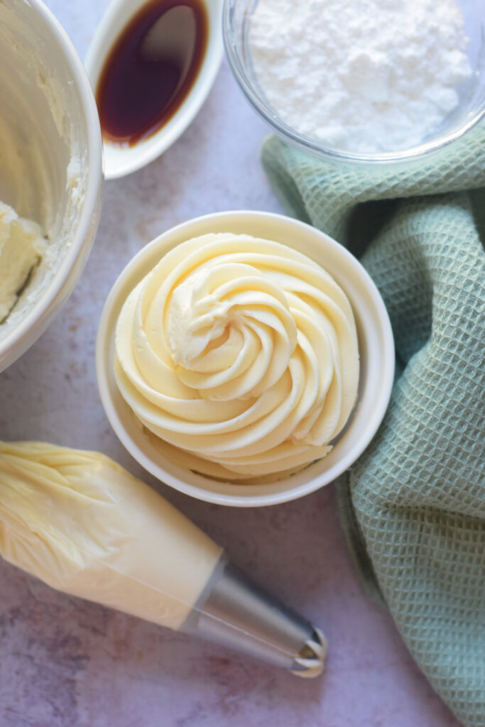 Whipped frosting in a white bowl.