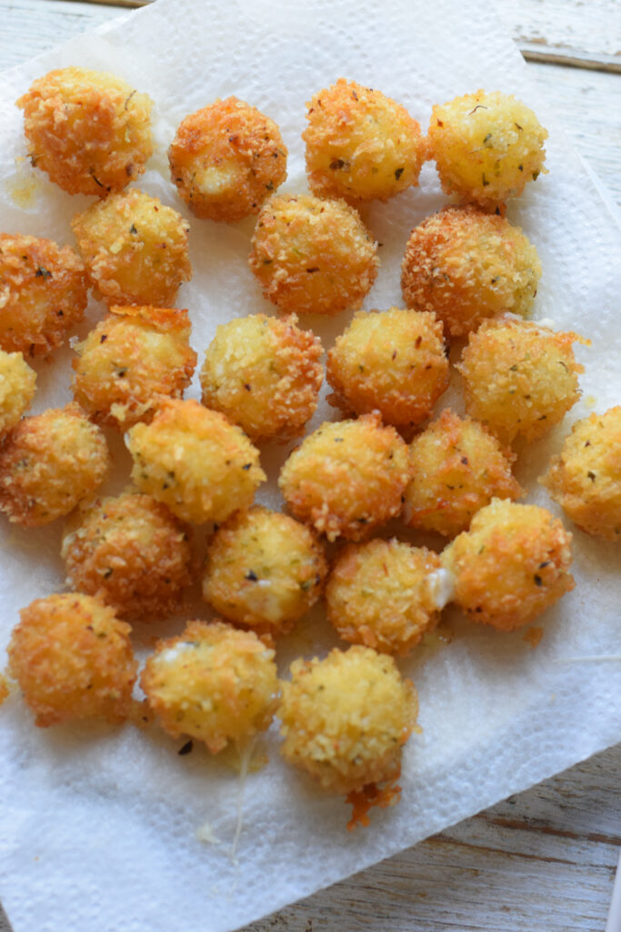 Fried mozzarella cheese balls on paper towels.