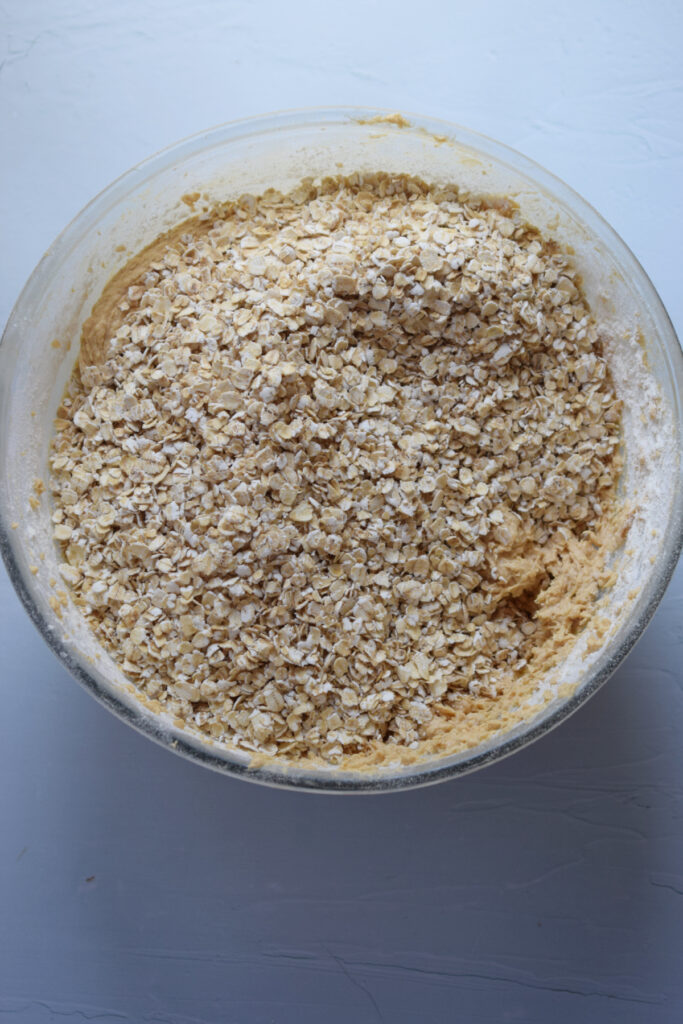 Making oatmeal cookies in a glass bowl.