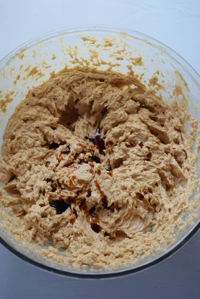 Making cookie dough in a glass bowl.