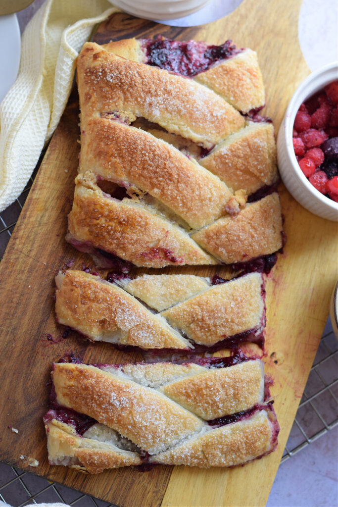 Berry danish on a wooden board.