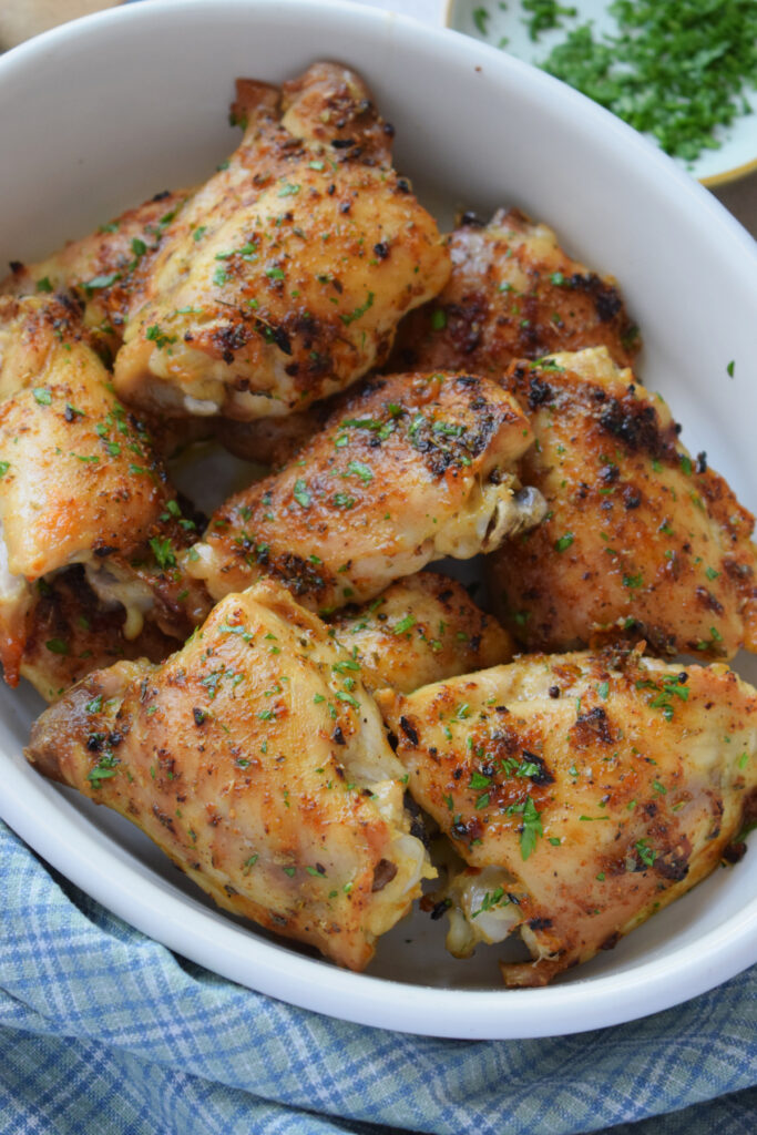 Easy oven baked chicken thighs in a serving dish.