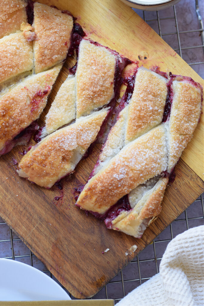 Close up of slices of a berry cream cheese danish.