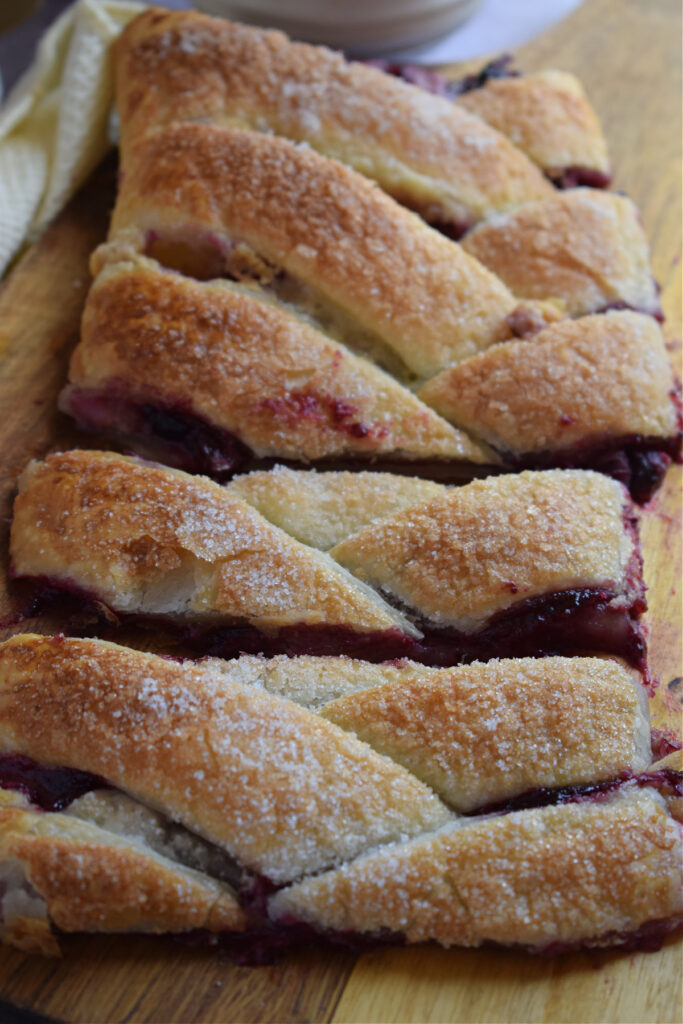 Close up of a berry danish on a board.