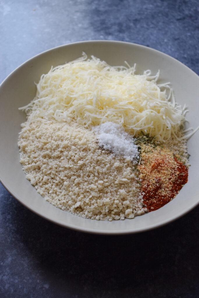 Making a bread crumb mixture in a bowl.