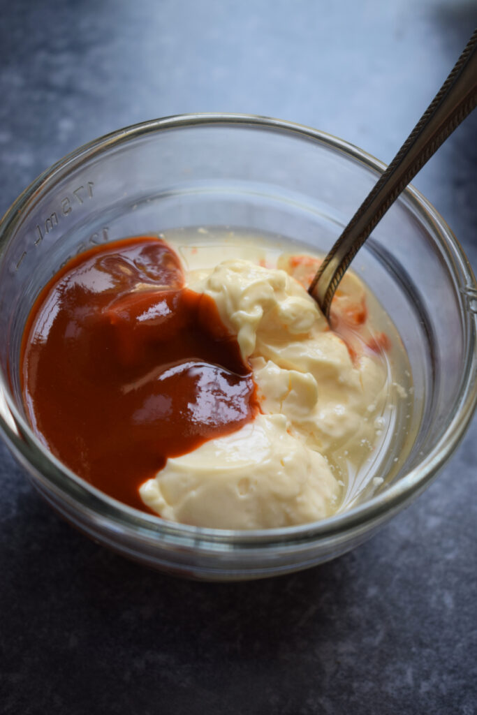 Making a dipping sauce in a small bowl.