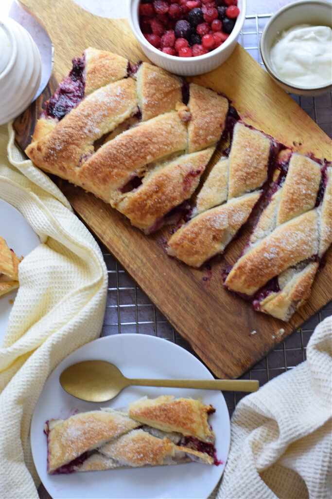 Danish on a wooden board and a slice on a plate.