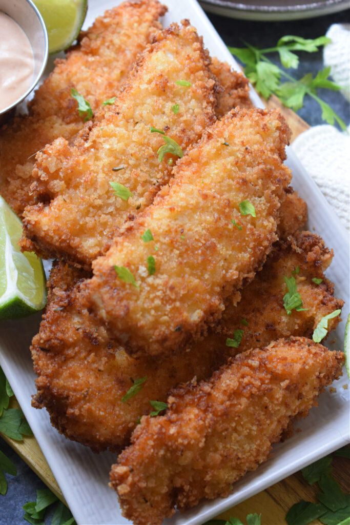 Fried chicken tenders on a plate.