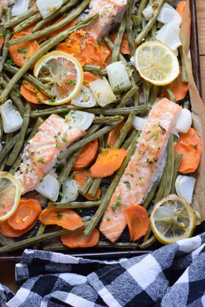 Salmon and vegetables on a baking tray.