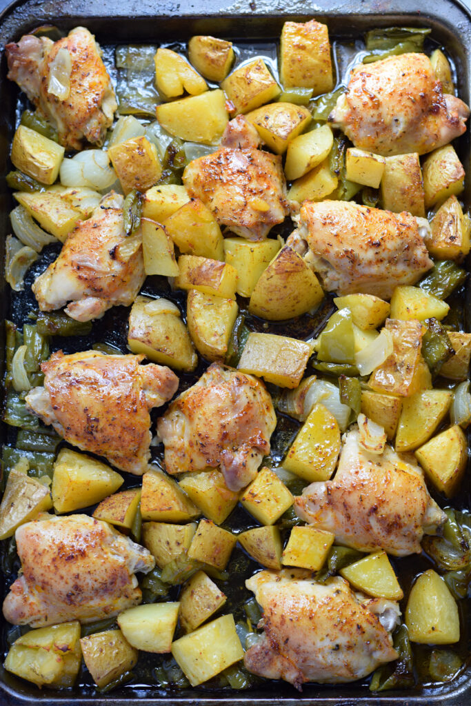 Sheet pan chicken dinner on a tray.