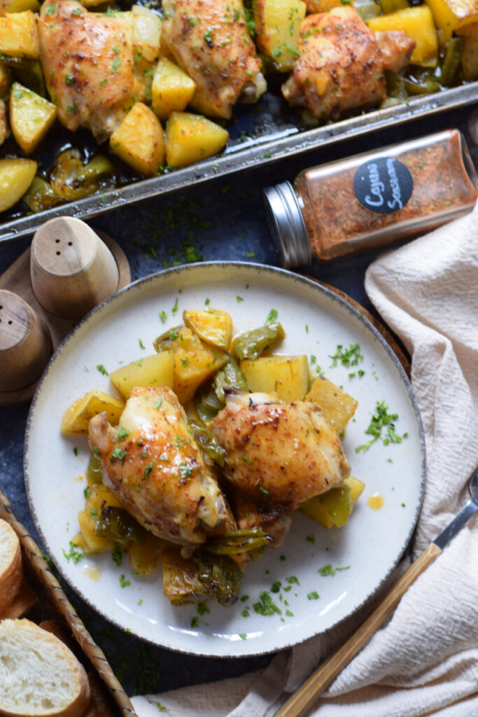 Cajun chicken dinner on a plate with vegetables.