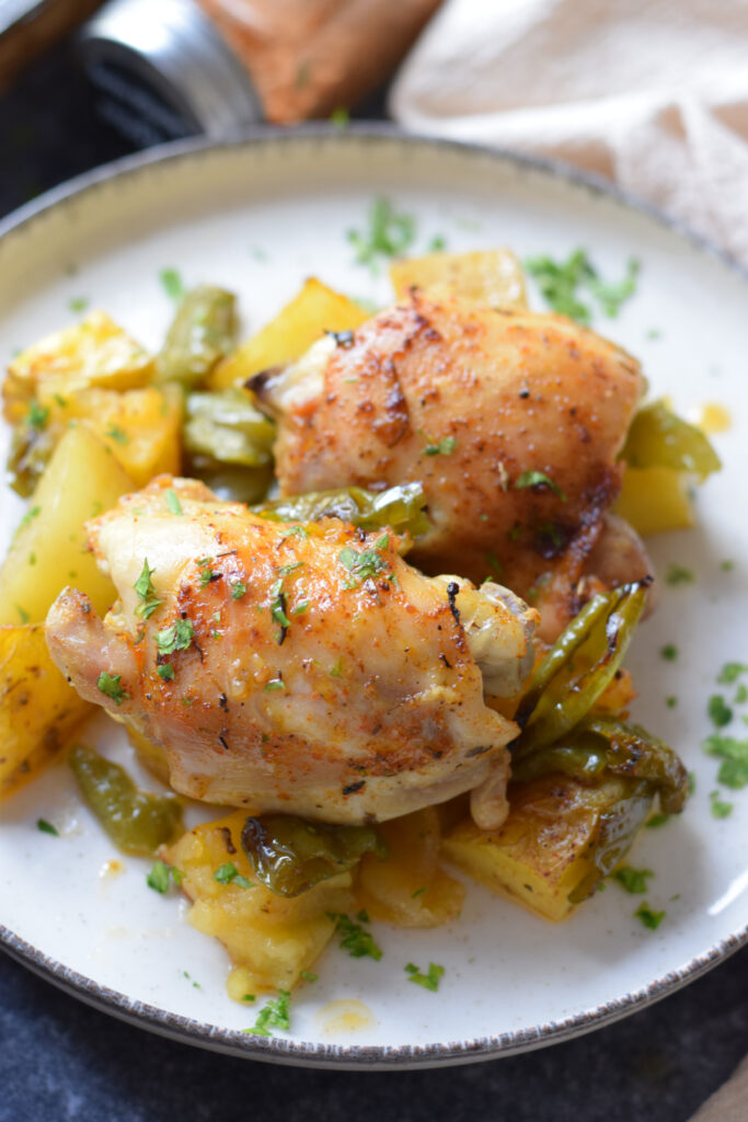 Close up of chicken and potatoes on a plate.