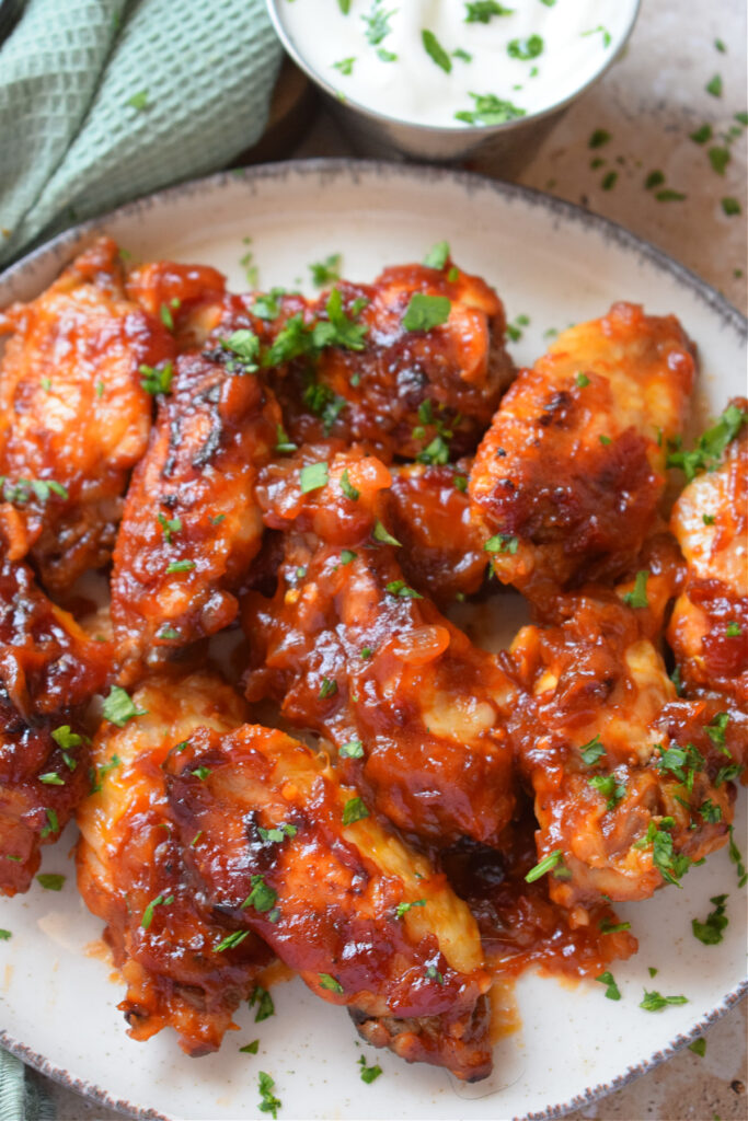 Barbecue style chicken wings on a plate.