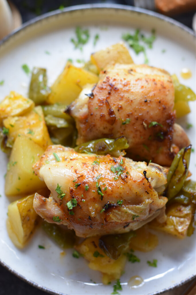 Close up of Cajun chicken and vegetables on a plate.