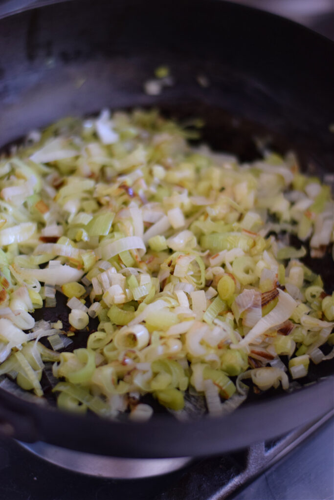 Cooked leeks in a skillet.