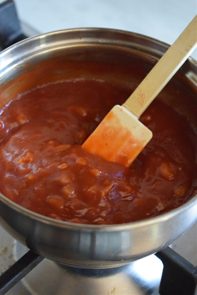 Cooking barbecue sauce in a saucepan.