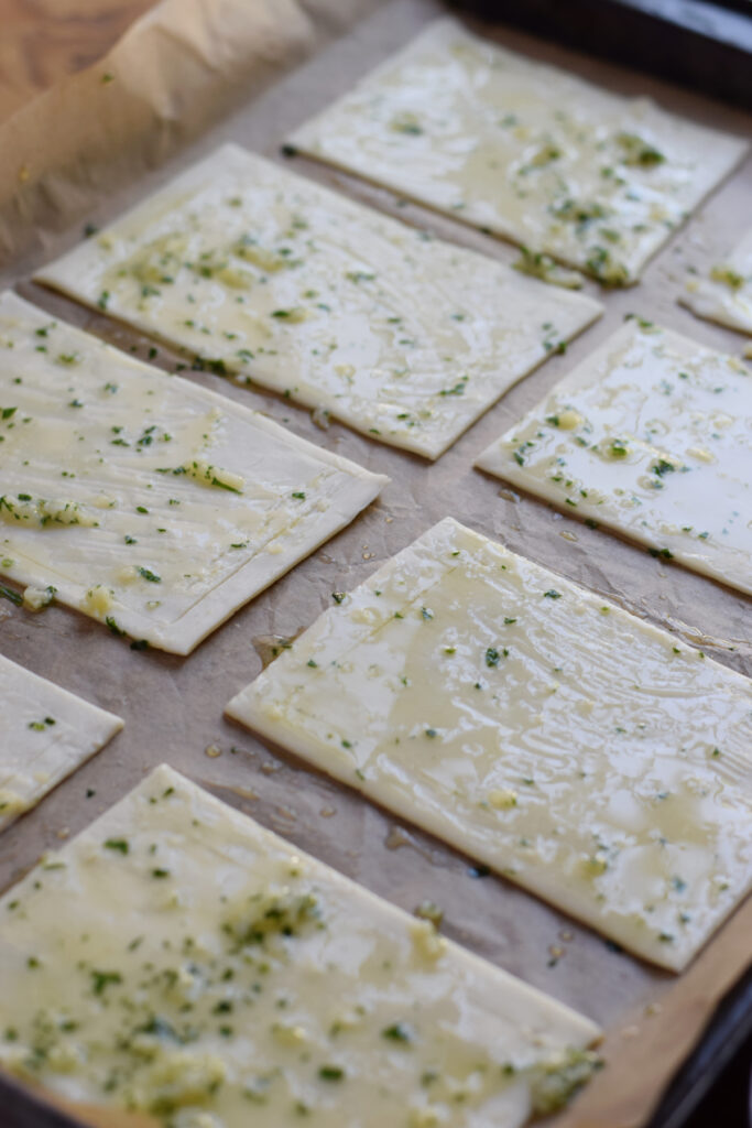 Puff pastry brushed with garlic butter.