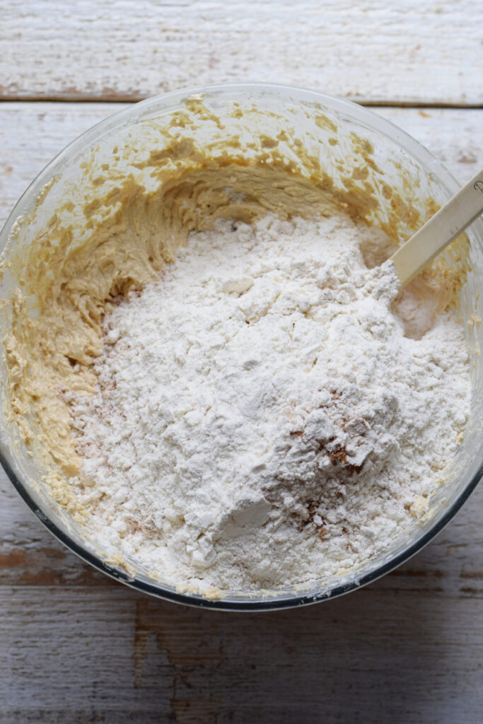 Adding flour to cookie dough.