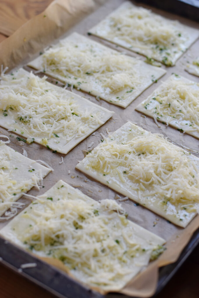 Puff pastry topped with parmesan cheese.