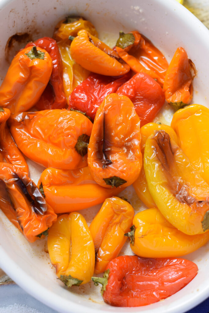 Roasted sweet mini peppers in a white dish.