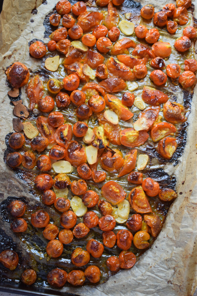 Roasted tomatoes on a baking tray.