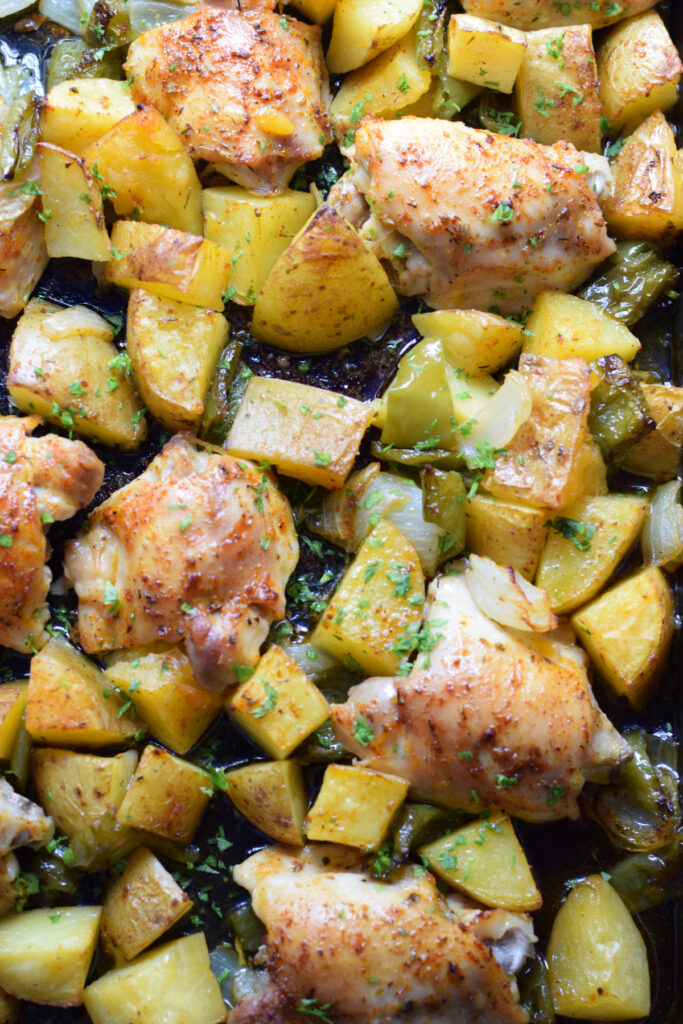 Sheet pan cajun chicken dinner on a tray.