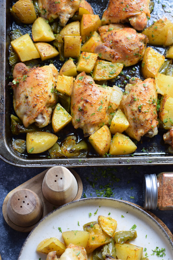 Chicken thighs and potatoes on a serving tray.