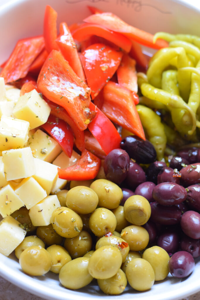 Making marinated olives and cheese in a bowl