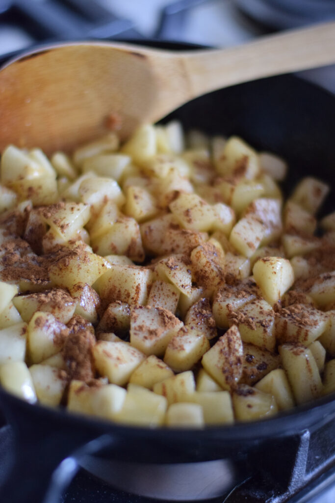 Cooking pears with cinnamon in a cast iron skillet.