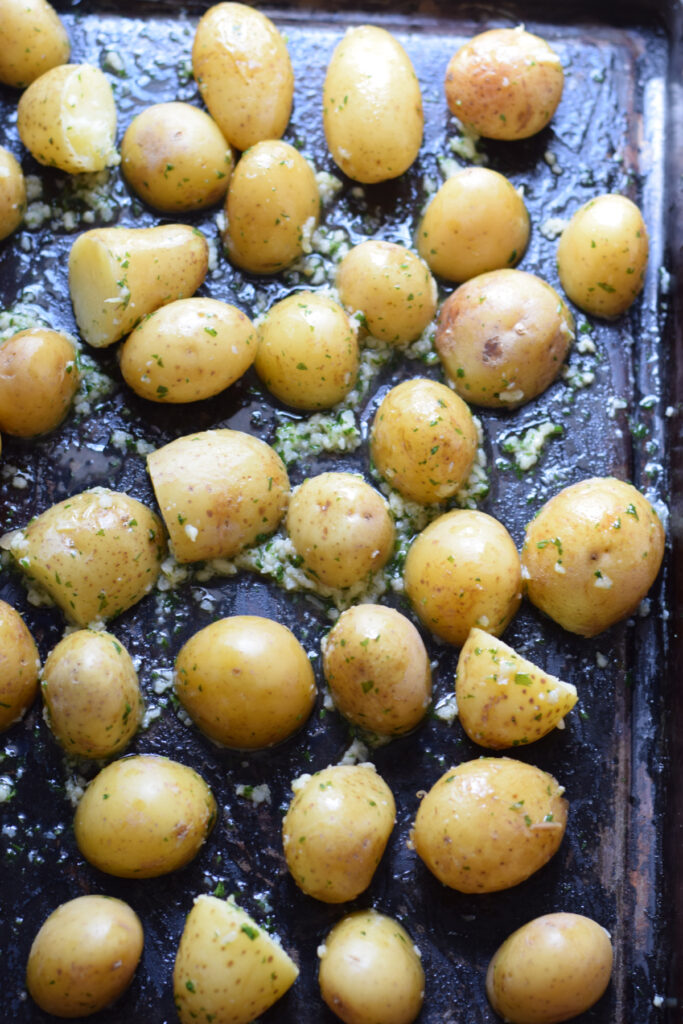 Potatoes on a tray ready to roast.