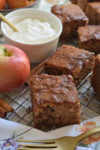 Apple cake squares with whipped cream.