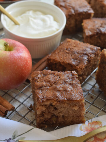 Apple cake squares with whipped cream.