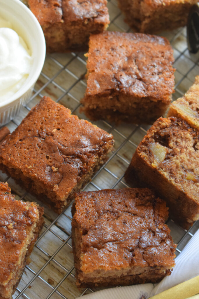 Apple cake squares on a baking tray.