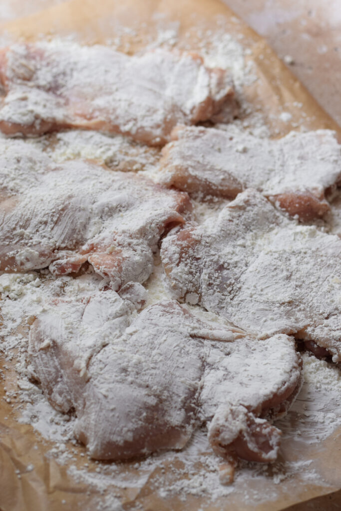 Chicken dredged in cornflour ready to cook.