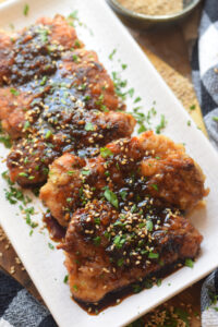 Garlic ginger chicken on a white plate.