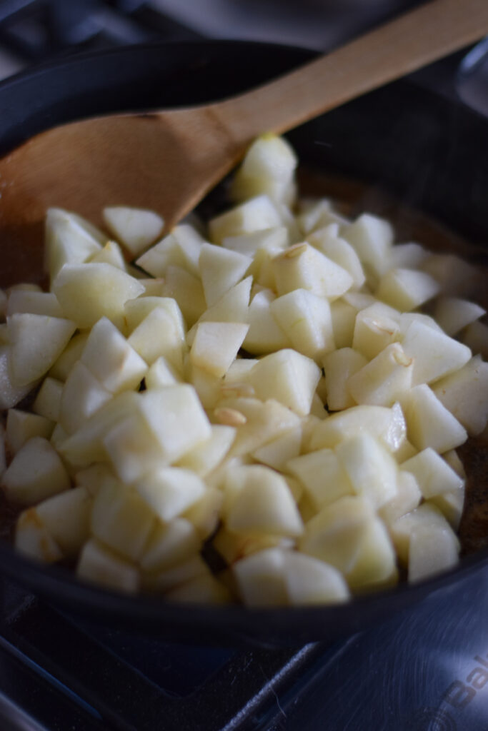 Adding pears to a cast iron skillet.