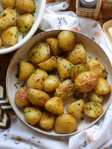 Potatoes roasted with garlic butter in a small bowl.