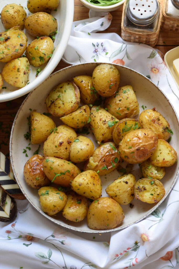 Potatoes roasted with garlic butter in a small bowl.